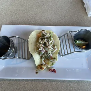 a taco on a plate with sauces