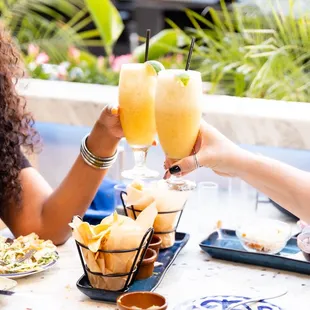 two women toasting with drinks