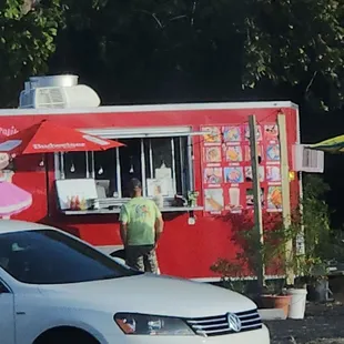 a man standing in front of a food truck
