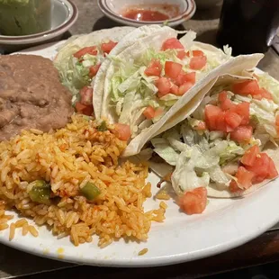 Fish tacos, with some good fish (though not enough) under all that vegetation. The rice is not bad, but the refried beans are really bland.