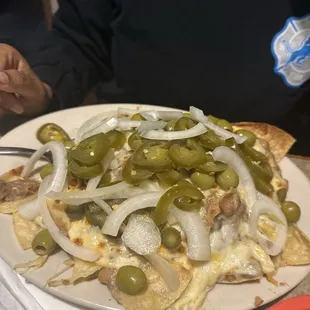 Small Nachos with beans, cheese and jalapeño and olives