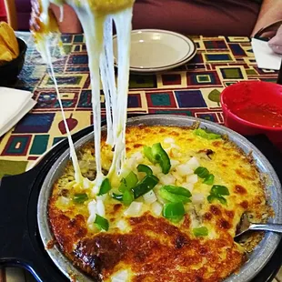 a plate of quesadilla with cheese and green onions