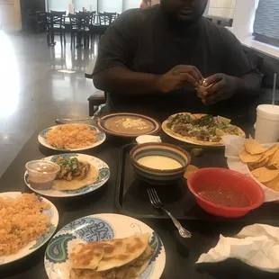 Chicken quesadilla, Mexican rice, queso, and tacos.