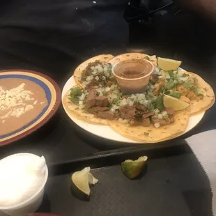 Steak and chicken tacos with refried beans.