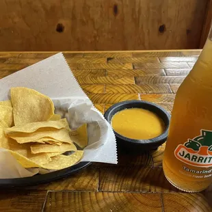 Complimentary chips and salsa with Jarritos tamarind soda
