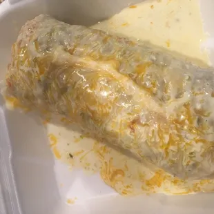 Steak breakfast burrito smothered in cheese