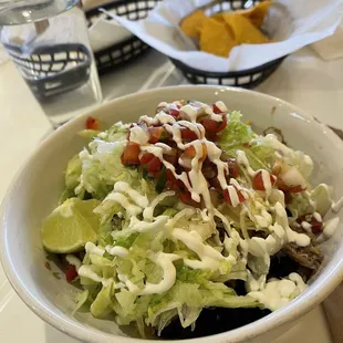 Christmas in a bowl. Actually carnitas w black beans, lettuce and some art.