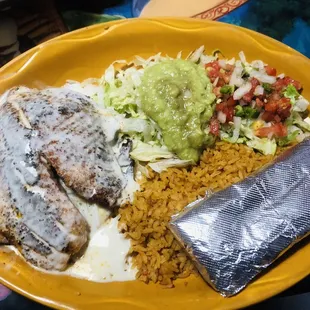 Filete Relleno. Which is grilled tilapia with melted cheese, Mexican rice and guacamole salad