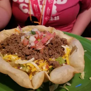 a taco with meat and cheese