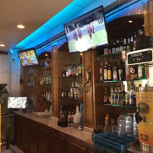 a bar with a television and drinks