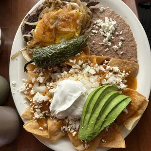 Chilaquiles rojo with steak and eggs very delicious