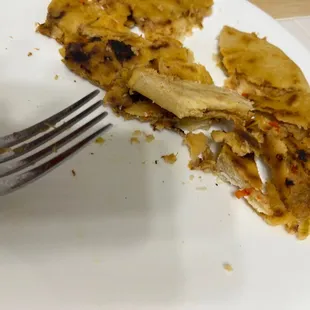 a half eaten pizza on a plate with a fork