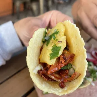 a person holding a taco