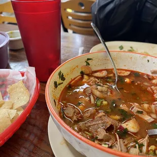 a bowl of soup with tortillas