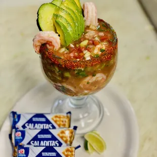 a margarita with shrimp and avocado garnish