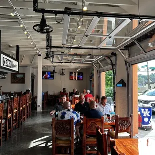 people sitting at tables in a restaurant