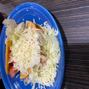 a blue plate with a taco on it