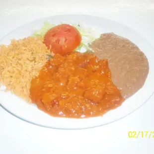 a plate of beans, rice, and tomatoes