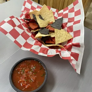 a bowl of chips and a bowl of salsa