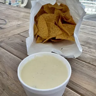 Order of chips and queso (to go). Enough for sharing or for leftovers.