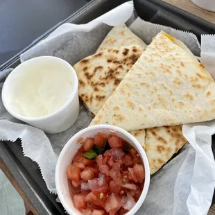 Chicken quesadilla to go. Included salsa and sour cream on side.