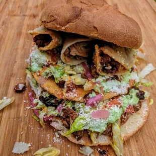 The Infamous TorTacoStada 

One Full Torta With One Full Tostada Topped With Three Tacos