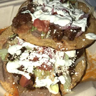 two tacos in a takeout container