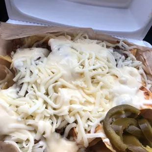 a plate of food in a styrofoam container