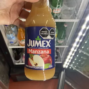 a person holding a bottle of juice