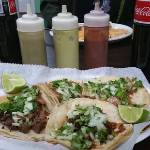 Chicken, barbacoa and suadero tacos; Sauces from left: tomatillo, avocado chili and red chili.