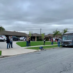  group of people standing in front of a bus
