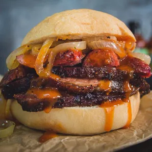Cowabunga sandwich- smoked brisket, beef sausage, grilled onions and our Original bbq sauce.