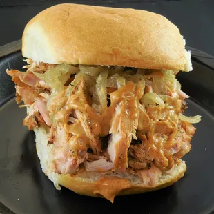 Cluckin' Awesome pulled chicken sandwich with grilled onions and chipotle lime mayo.