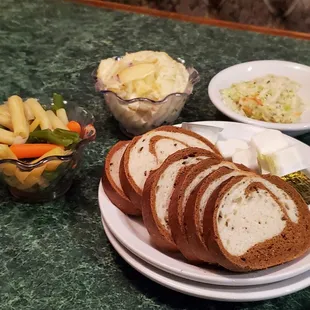 Sides of pickled veggies, potato salad, cole slaw, and rye bread included with my fish fry.