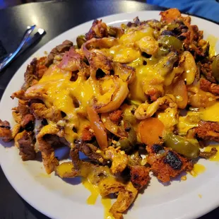 Mr Potato, basically a baked potato covered with chicken, shrimp, and chorizo nacho fixings. BF&apos;s  fav.