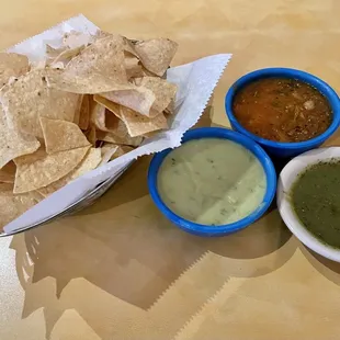 Complimentary chips and salsa. Chips come with the red salsa. You have to ask for the others.