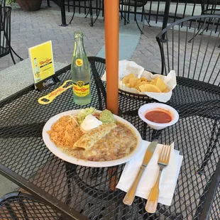 Carnitas Enchilada w/ rice, pinto beans &amp; guac. Chips and medium salsa. Topo Chico mineral water. ¡Delicioso!