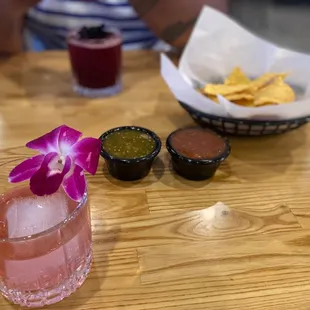 a pink drink and chips