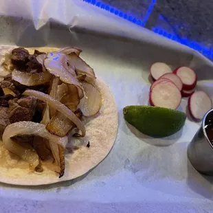 BISTEC TACO - Flank steak with caramelized onions, cilantro, and tomatillo