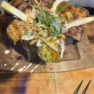Molecajete with chicken, steak, cactus, ground beef