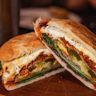 La Torta: Telera bread, mayo, refried black beens, sliced turkey, lettuce, quesillo, avocado, pickled red onions (chicken or chorizo)