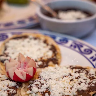 Memelitas: Handmade corn tortillas, brushed with pork crackling spread, black bean puree, and quest fresco