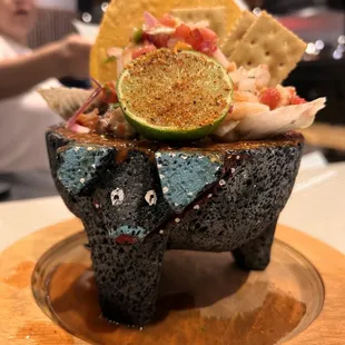 an elephant with a lime in its mouth