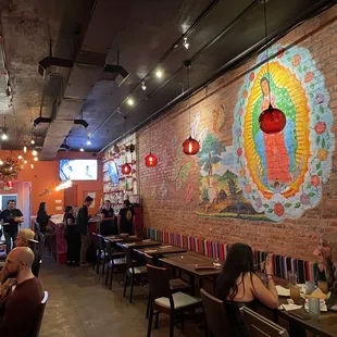 people sitting at tables in a mexican restaurant
