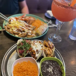 a plate of mexican food and a drink