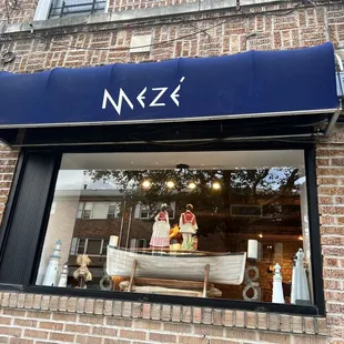 a storefront with a boat in the window