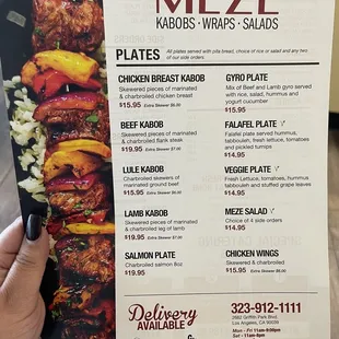 a person holding up a menu