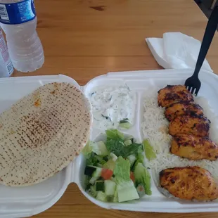 Chicken kabob, rice, tzatziki, and a small salad with pita
