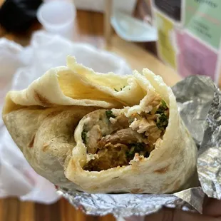 a hand holding a burrito