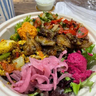 Mixed greens, pickles onions, eggplant, beet hummus. Tomato and cucumber salad, shug sauce, tzatziki sauce